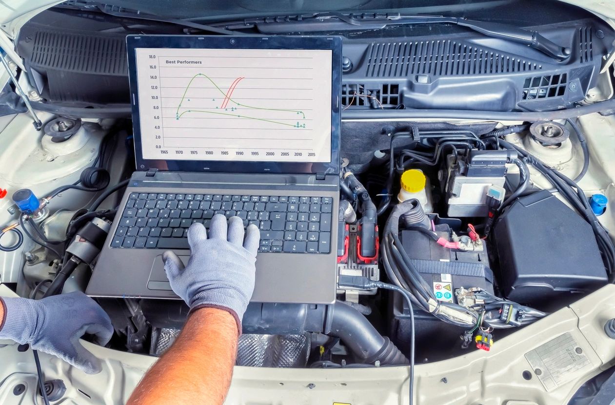 Professional car mechanic working in auto repair computer service Professional car mechanic working in auto repair computer service